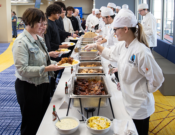 Attendees of the Soul Food Luncheon in line getting food